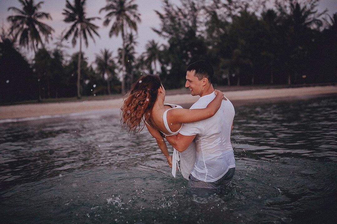 Toes in sand, hearts intertwined